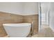 Bright bathroom with a modern soaking tub and stylish wood tile flooring at 3123 Neal Ct, Cumming, GA 30041