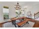 Spacious dining room with stylish wooden table, bench seating, and decorative lighting, ready for memorable gatherings at 3123 Neal Ct, Cumming, GA 30041