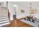 Inviting dining room features hardwood floors, stylish lighting, and a cozy farmhouse-style table with bench seating at 3123 Neal Ct, Cumming, GA 30041