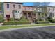 Brick townhome showcasing manicured landscaping, covered porch, and traditional architectural details at 3123 Neal Ct, Cumming, GA 30041
