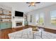Bright living room featuring a fireplace with stone surround, custom shelving, and access to a balcony at 3123 Neal Ct, Cumming, GA 30041