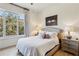 Cozy bedroom featuring a plush queen bed, neutral decor, and a large window overlooking greenery at 1430 Dresden Ne Dr # 200, Atlanta, GA 30319