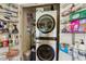 Organized laundry room with stacked washer and dryer, complemented by ample shelving for supplies at 1430 Dresden Ne Dr # 200, Atlanta, GA 30319