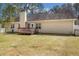 Spacious backyard featuring a wooden deck, lawn, and a view of the home's back exterior at 170 Double D Rd, Temple, GA 30179