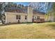 View of a backyard, showing the home's back exterior, wooden deck, and grassy lawn at 170 Double D Rd, Temple, GA 30179