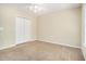 A comfortable bedroom with carpet floors, a ceiling fan, and a closet at 170 Double D Rd, Temple, GA 30179