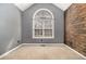 Bedroom featuring an arched window, gray walls, and wood accent wall at 170 Double D Rd, Temple, GA 30179