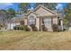 A charming ranch home with symmetrical windows, neutral siding, and neatly trimmed shrubs enhances its curb appeal at 170 Double D Rd, Temple, GA 30179