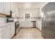 Bright kitchen featuring white cabinets, stainless steel appliances, and tile floors at 170 Double D Rd, Temple, GA 30179
