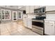 Bright kitchen with stainless steel appliances, tile floors, and view of the backyard at 170 Double D Rd, Temple, GA 30179