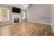 Bright living room with hardwood floors, vaulted ceiling, fireplace, and large windows at 170 Double D Rd, Temple, GA 30179
