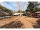 A large backyard with mature trees, a fenced pool, and a view of the home's back exterior at 2443 Highway 92 S, Fayetteville, GA 30215