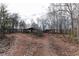 An expansive, wooded lot with a covered structure, presenting a serene and natural setting at 2443 Highway 92 S, Fayetteville, GA 30215