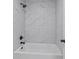 Bathroom featuring tub and shower combo, gray veined tiles and a sleek black showerhead at 4190 Hosch Reserve Dr, Buford, GA 30519
