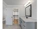 Bright bathroom with gray cabinets, white countertop, and framed mirror at 4190 Hosch Reserve Dr, Buford, GA 30519