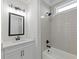 Well-lit bathroom features tiled shower with rain shower head and black hardware at 4190 Hosch Reserve Dr, Buford, GA 30519