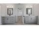 Bright bathroom features dual sinks, framed mirrors, and an open doorway to another room at 4190 Hosch Reserve Dr, Buford, GA 30519