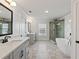 Bathroom featuring dual sinks, soaking tub, shower, and modern fixtures and finishes at 4190 Hosch Reserve Dr, Buford, GA 30519