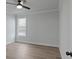 Bright bedroom featuring sleek ceiling fan and a large window with light hardwood flooring at 4190 Hosch Reserve Dr, Buford, GA 30519