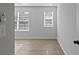 Bedroom with wood flooring and two windows at 4190 Hosch Reserve Dr, Buford, GA 30519