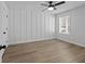 Bedroom featuring hardwood floors, neutral walls, accent wall and ceiling fan at 4190 Hosch Reserve Dr, Buford, GA 30519