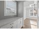 Hallway features sleek gray backsplash and white built-in shelving at 4190 Hosch Reserve Dr, Buford, GA 30519