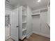 Walk-in closet has custom shelving, wood floors, and an ensuite bath with glass shower at 4190 Hosch Reserve Dr, Buford, GA 30519
