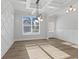 Bright dining room featuring hardwood floors, modern lighting, wainscoting, and beautiful ceiling details at 4190 Hosch Reserve Dr, Buford, GA 30519
