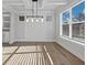 Sunlit dining room features elegant wainscoting, hardwood floors, and modern lighting fixtures at 4190 Hosch Reserve Dr, Buford, GA 30519