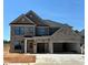 Beautiful two-story brick home featuring a spacious three-car garage and a modern craftsman-style design at 4190 Hosch Reserve Dr, Buford, GA 30519