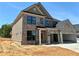 Charming brick home with a two-car garage, offering a blend of classic and contemporary design elements at 4190 Hosch Reserve Dr, Buford, GA 30519