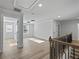 Bright hallway features hardwood floors, white trim, and staircase with wood and iron railing at 4190 Hosch Reserve Dr, Buford, GA 30519