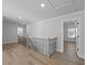 Upstairs hallway with wood floors and modern railing at 4190 Hosch Reserve Dr, Buford, GA 30519