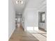 Hallway with hardwood floors and neutral-colored walls leading to dining area at 4190 Hosch Reserve Dr, Buford, GA 30519