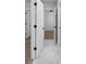 Hallway with white marble tile, bright lighting and access to several rooms at 4190 Hosch Reserve Dr, Buford, GA 30519
