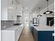 Gourmet kitchen features a navy island, stainless appliances, and sleek countertops at 4190 Hosch Reserve Dr, Buford, GA 30519