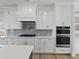 Modern kitchen featuring white cabinetry, stainless steel appliances, and a stylish subway tile backsplash at 4190 Hosch Reserve Dr, Buford, GA 30519