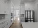 Bright kitchen with white cabinets, stainless steel appliances, and an open layout perfect for entertaining at 4190 Hosch Reserve Dr, Buford, GA 30519