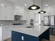Stylish kitchen featuring a central island with modern appliances and elegant pendant lighting fixtures at 4190 Hosch Reserve Dr, Buford, GA 30519