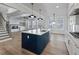 Stylish kitchen features a navy island, white cabinets, quartz countertops, stainless appliances, and open view to living area at 4190 Hosch Reserve Dr, Buford, GA 30519