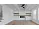 Bright living room features a fireplace with floating shelves and a modern ceiling fan at 4190 Hosch Reserve Dr, Buford, GA 30519