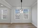 Bright living room with large windows, wood floors, and modern lighting creating a warm and inviting space at 4190 Hosch Reserve Dr, Buford, GA 30519