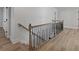 A staircase featuring modern wooden handrails and black metal spindles leading upstairs at 4190 Hosch Reserve Dr, Buford, GA 30519