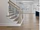 Staircase with wooden treads and iron railings leads to a spacious living area with ample natural light at 4190 Hosch Reserve Dr, Buford, GA 30519