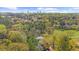 A beautiful aerial view of a home surrounded by lush greenery and a city skyline in the background at 4635 High Point Rd, Atlanta, GA 30342