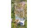 Aerial view of a home showcasing its landscaped yard, driveway, and surrounding greenery at 4635 High Point Rd, Atlanta, GA 30342