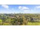 An aerial view of lush green trees, some residential homes, and a city skyline in the background at 4635 High Point Rd, Atlanta, GA 30342