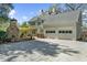 Backyard view featuring an outdoor fireplace, a patio area and an attached two-car garage at 4635 High Point Rd, Atlanta, GA 30342