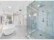 This bathroom features a glass shower, a soaking tub, a vanity, and natural light from a window at 4635 High Point Rd, Atlanta, GA 30342
