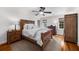 This bedroom features hardwood floors, a wood bed frame, a wood dresser and plenty of natural light at 4635 High Point Rd, Atlanta, GA 30342